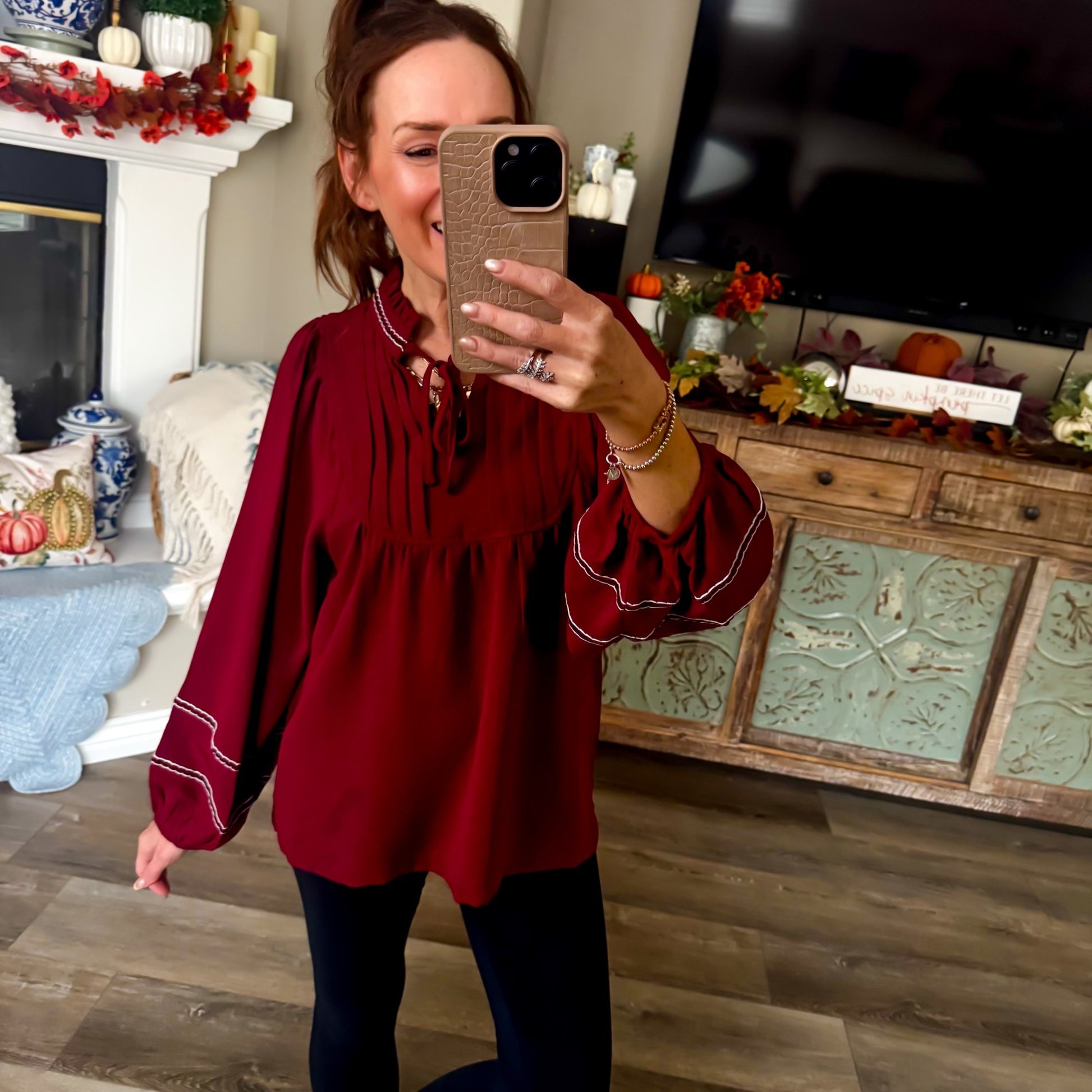Burgundy babydoll blouse with white scalloped stitching