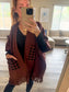 Brown poncho with black polka dot pockets