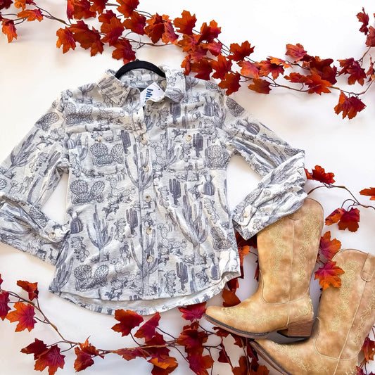 Blue B cactus cowboy toile button up shirt flat lay with boots