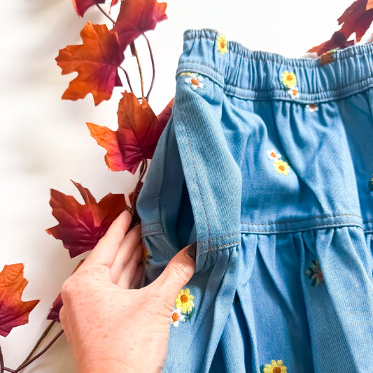 Embroidered daisy denim skirt waist and pocket detail