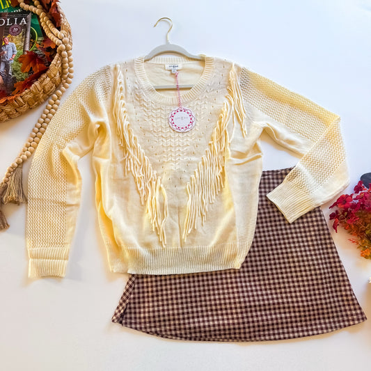 Cream fringe sweater flat lay