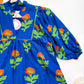 Marigold floral dress bib and sleeve detail