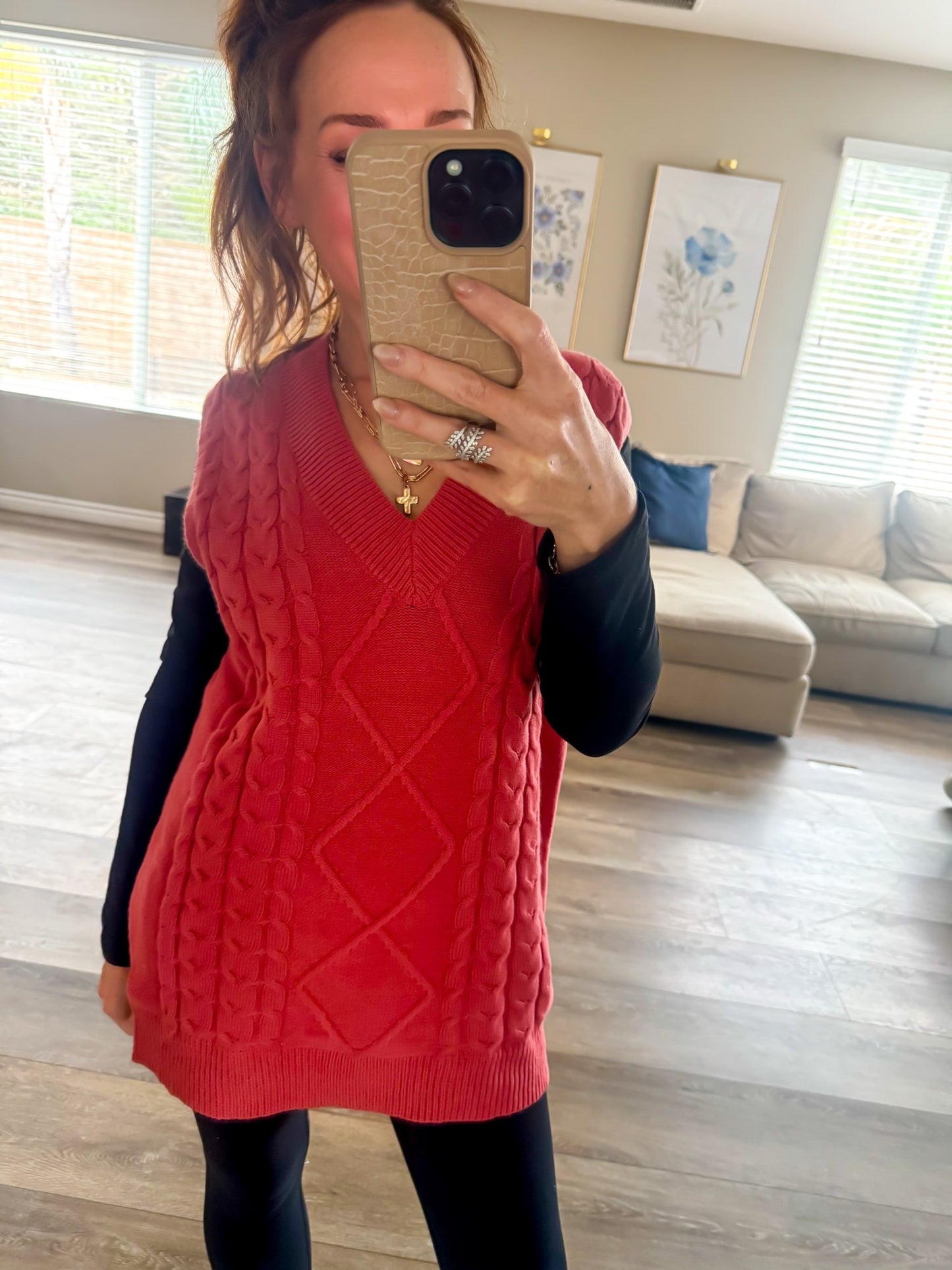 Coral cable knit vest styled with black long sleeve